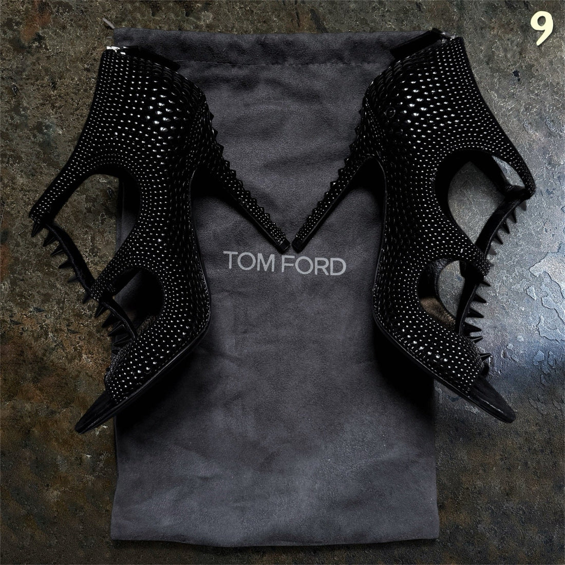 Black Tom Ford heels with glossy studs, projecting spikes and side cutouts, photographed for ninesells.