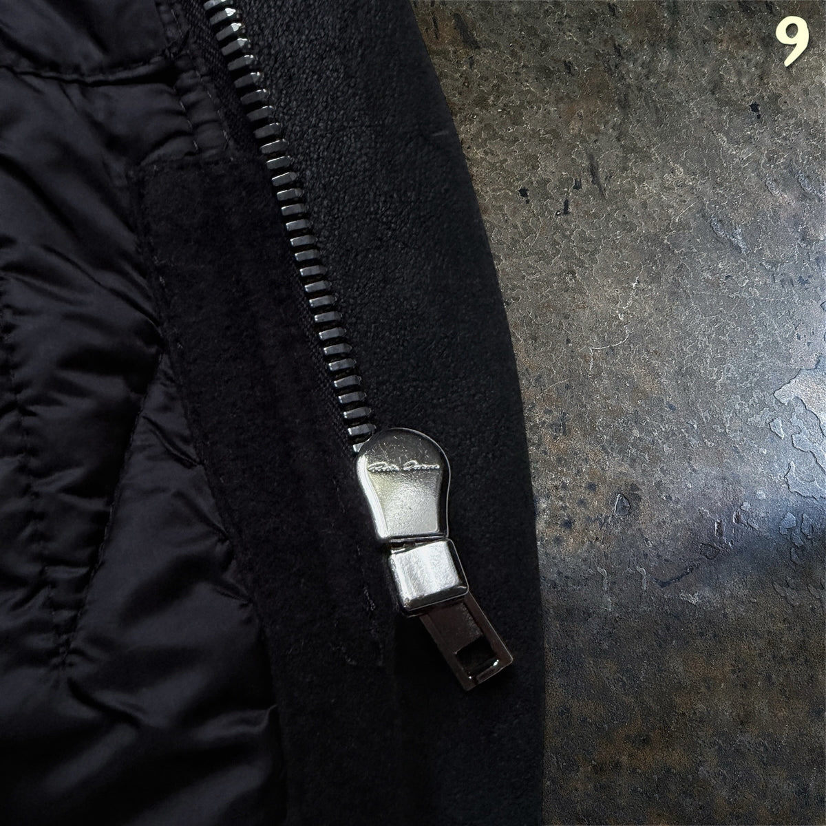 Rick Owens Larry coat, close-up of the zip pull beside the quilted lining