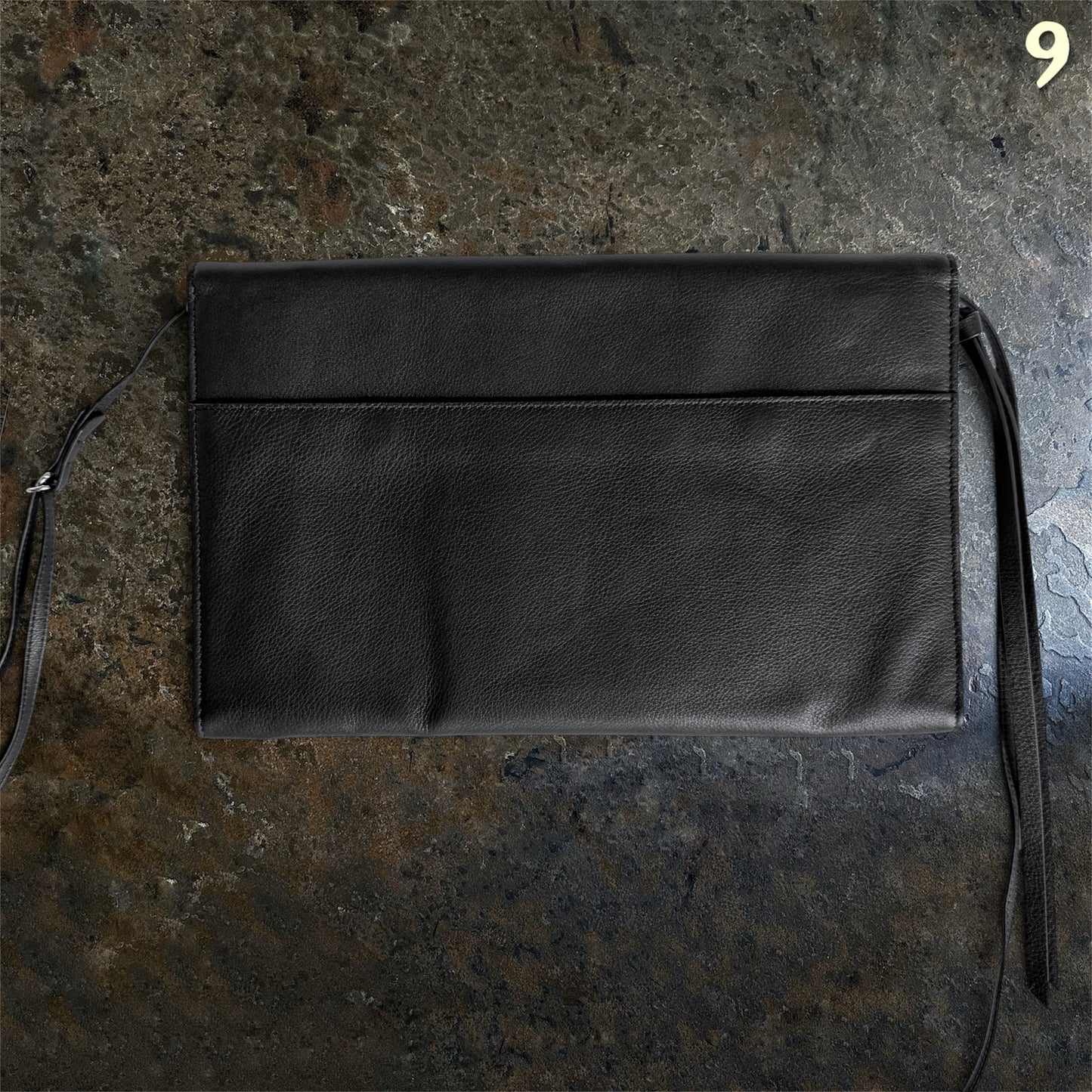 Back view of Ann Demeulemeester black full-grain leather shoulder bag